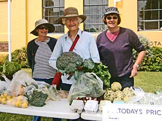 Lyndsay, Belinda, Rosli and broccoli on the Seasonal Surplus Stall