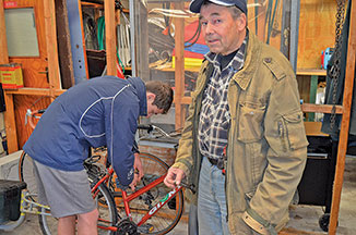 Troy Harris and Tony Evans work on a bike